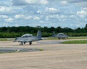 Two AT-6 aircraft taxi on the runway during Enduring Partners on August 19, 2025 at Korat Royal Thai Air Force Base, Thailand.