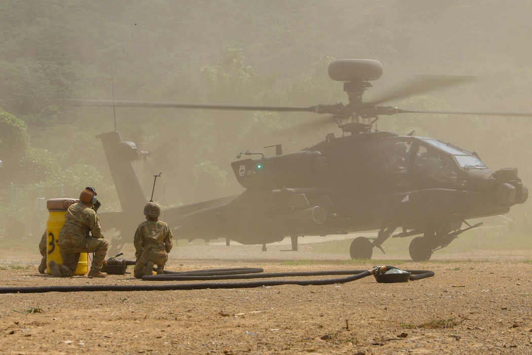 Sgt. Clayton Odneal and Pfc. Maddyson Woods, petroleum supply specialists assigned to 3rd Battalion, 2nd General Support Aviation Battalion, 2nd Combat Aviation Brigade, 2d Infantry Division/ROK-U.S. Combined Division, prepares for refueling operations of a AH-64 Apache during Ulchi Freedom Shield on Deju Island, South Korea, Aug. 21, 2025.