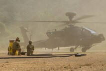 Sgt. Clayton Odneal and Pfc. Maddyson Woods, petroleum supply specialists assigned to 3rd Battalion, 2nd General Support Aviation Battalion, 2nd Combat Aviation Brigade, 2d Infantry Division/ROK-U.S. Combined Division, prepares for refueling operations of a AH-64 Apache during Ulchi Freedom Shield on Deju Island, South Korea, Aug. 21, 2025.
