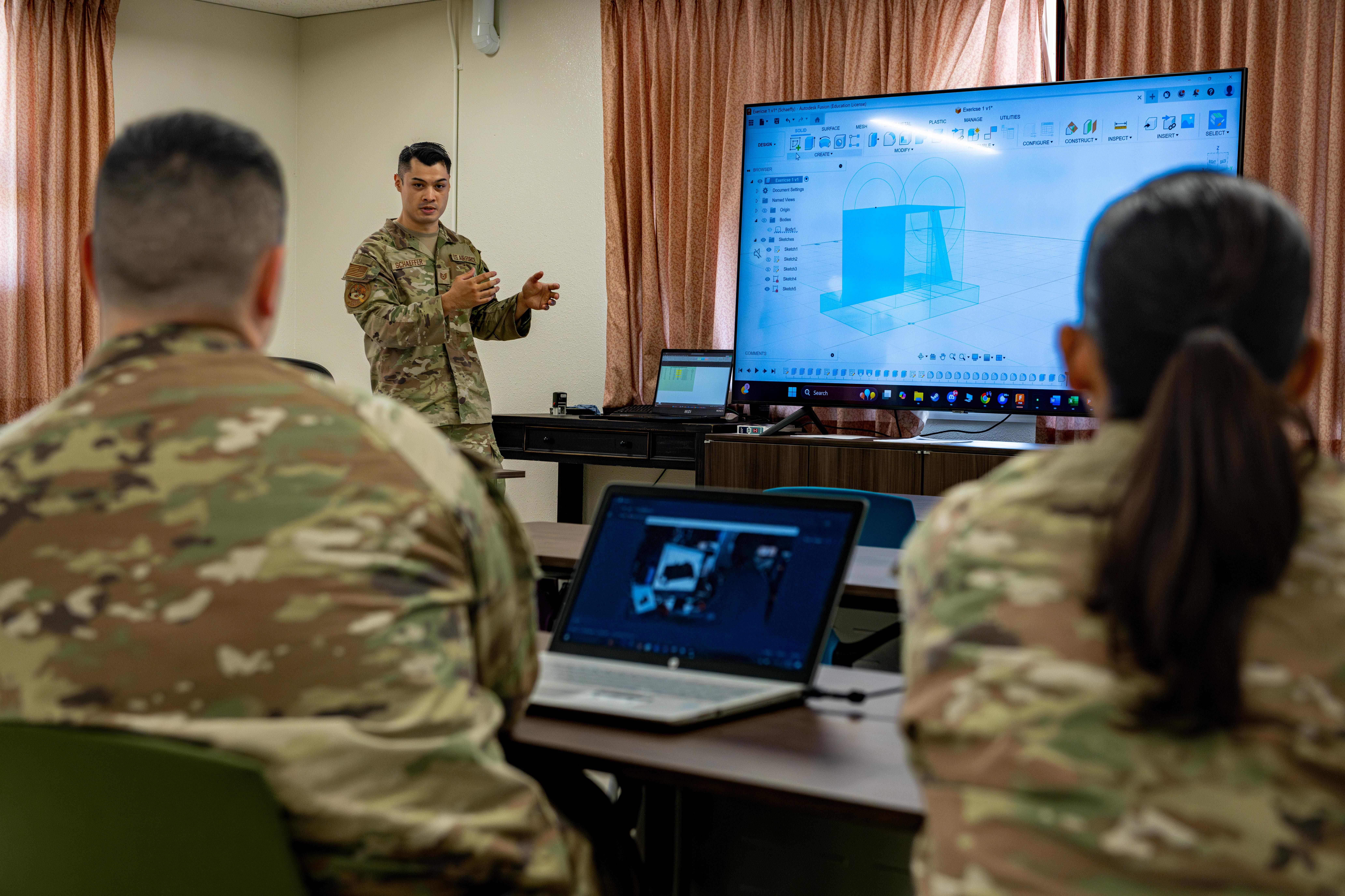 U.S. Air Force Tech. Sgt. Andrew Schaeffer, Project Arc director of innovation, lectures a manufacturing and design course at Misawa Air Base, Japan, Aug. 18, 2025. The course equips Airmen with hands-on 3D printing skills to rapidly produce mission-essential parts, strengthening the 35th Fighter Wings and the Air Force’s readiness and innovation capabilities. (U.S. Air Force photo by Airman Hannah Bench)