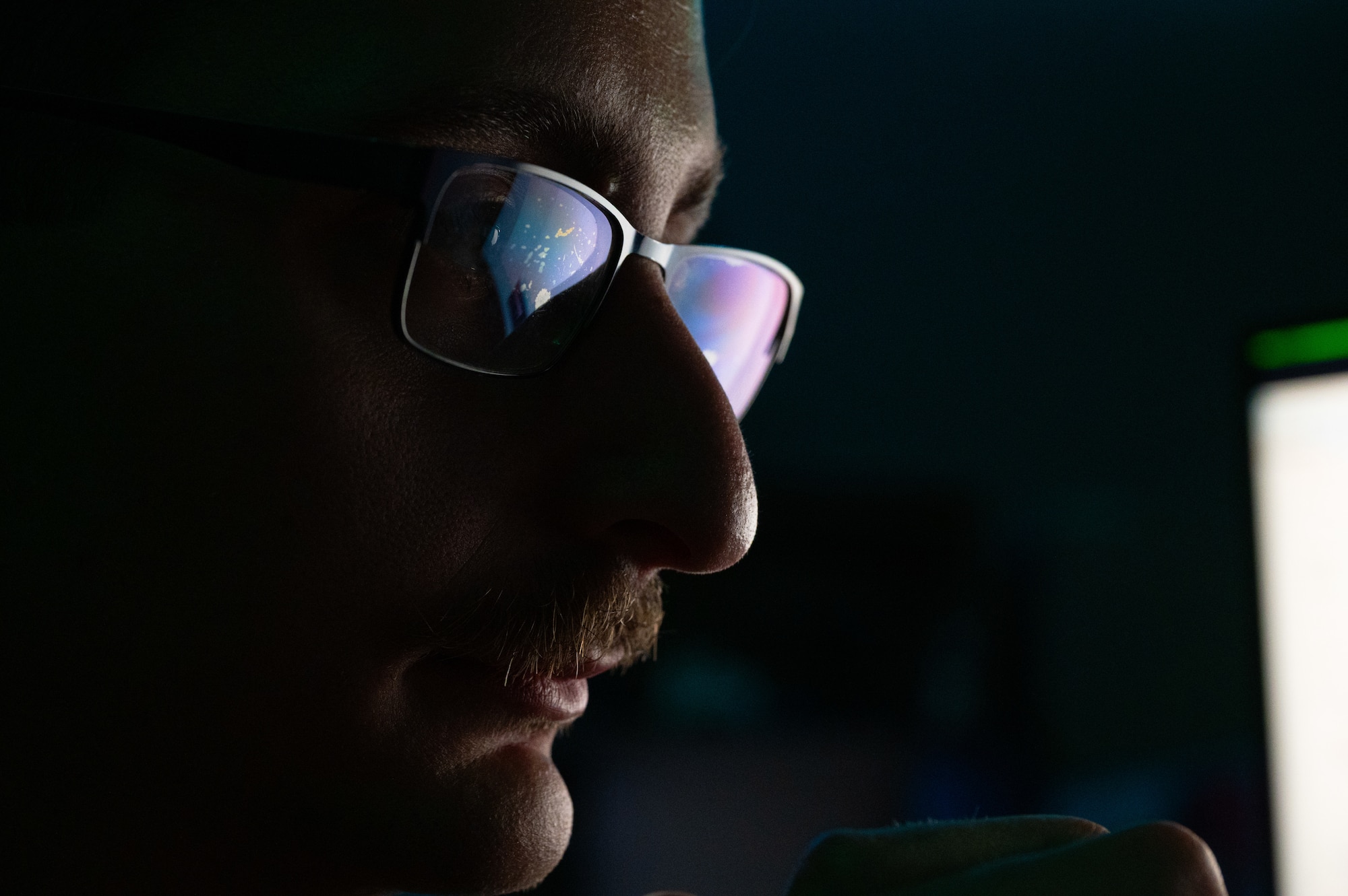U.S. Air Force Senior Airman Nicholas Agriesti, 509th Communications Squadron cyber readiness technician, looks through code on his computer at Whiteman Air Force Base, Missouri, Aug. 11, 2025. Agriesti is part of the Security, Hardening, Lifecycle and Defense team, which helps ensure cyber security compliance across the installation by providing cyber protection to electronic devices. (U.S. Air Force photo by Senior Airman Joseph Garcia)