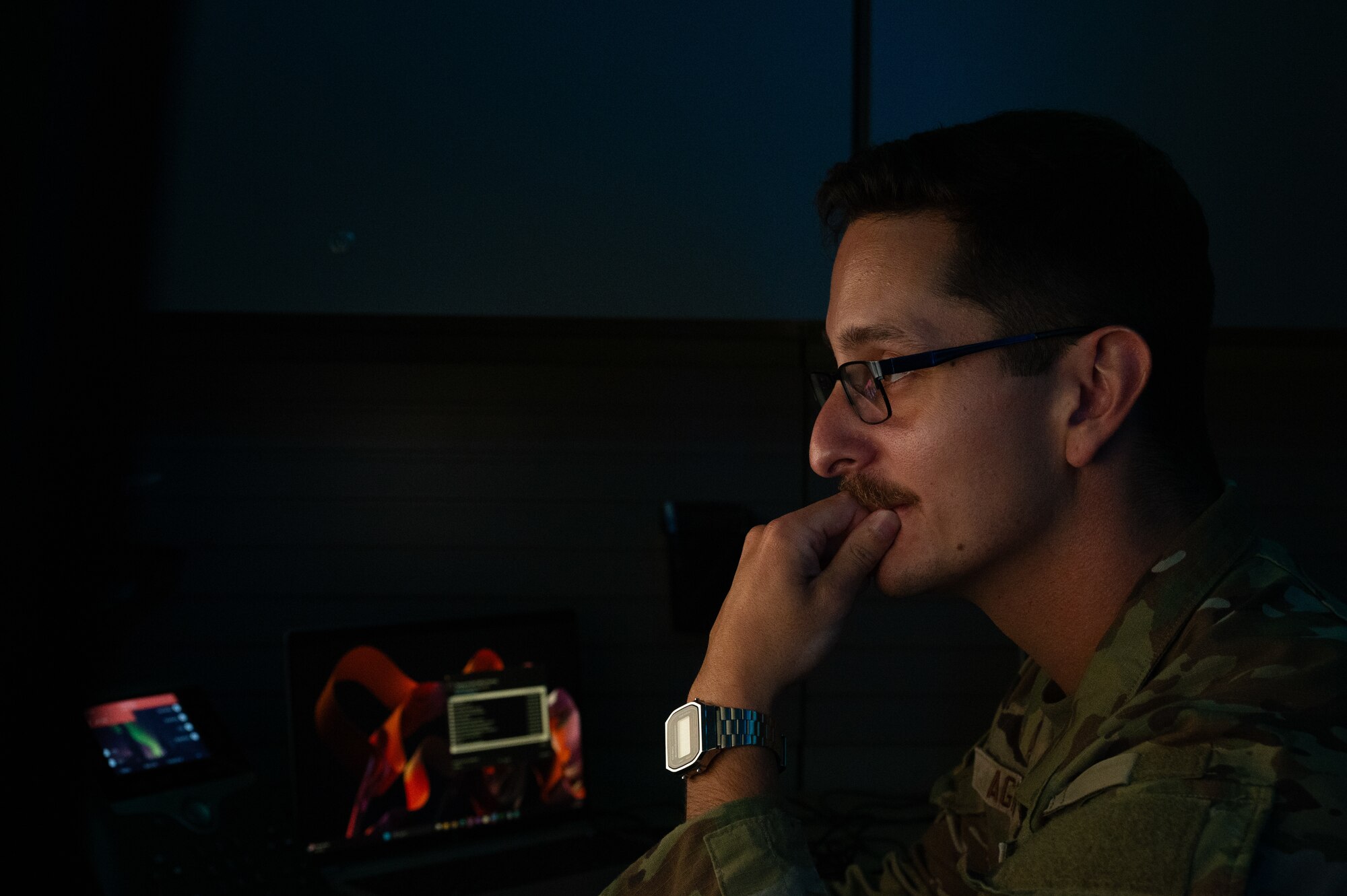 U.S. Air Force Senior Airman Nicholas Agriesti, 509th Communications Squadron cyber readiness technician, looks through code on his computer at Whiteman Air Force Base, Missouri, Aug. 11, 2025. Agriesti is part of the Security, Hardening, Lifecycle and Defense team, which helps ensure cyber security compliance across the installation by providing cyber protection to electronic devices. (U.S. Air Force photo by Senior Airman Joseph Garcia)