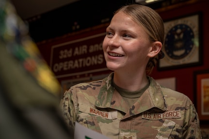 Staff Sgt. Eleanor Warren smiles while speaking to other Airmen