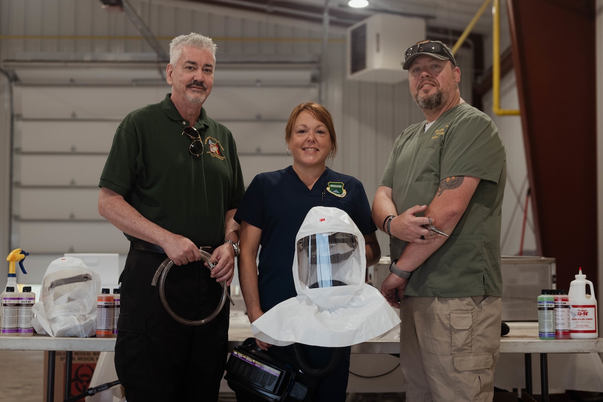 Matthew McCloskey, Air Force Mortuary Affairs past conflicts and training, Danielle Wilk, AFMAO port mortuary branch chief, and Matthew Metschke, AFMAO case management branch chief, participate in exercise Northern Strike 25-2 by creating the exercise’s first expeditionary mortuary and embalming suite at Grayling Army Airfield, Michigan, Aug. 12, 2025. The three embalmers were able to show AFMAO’s capability to embalm in 30-minutes in a contested environment or mass-casualty event. (U.S. Air Force photo by Senior Airman Madeline Baisey)