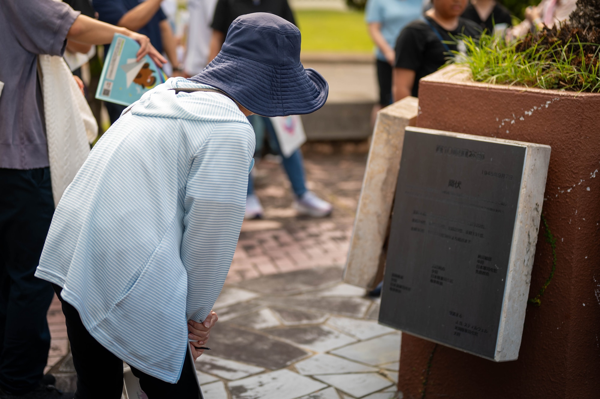 A local resident looks at a plaque displaying information about the Peace Garden memorial during a historical site tour of Kadena Air Base, Japan, Aug. 13, 2025.