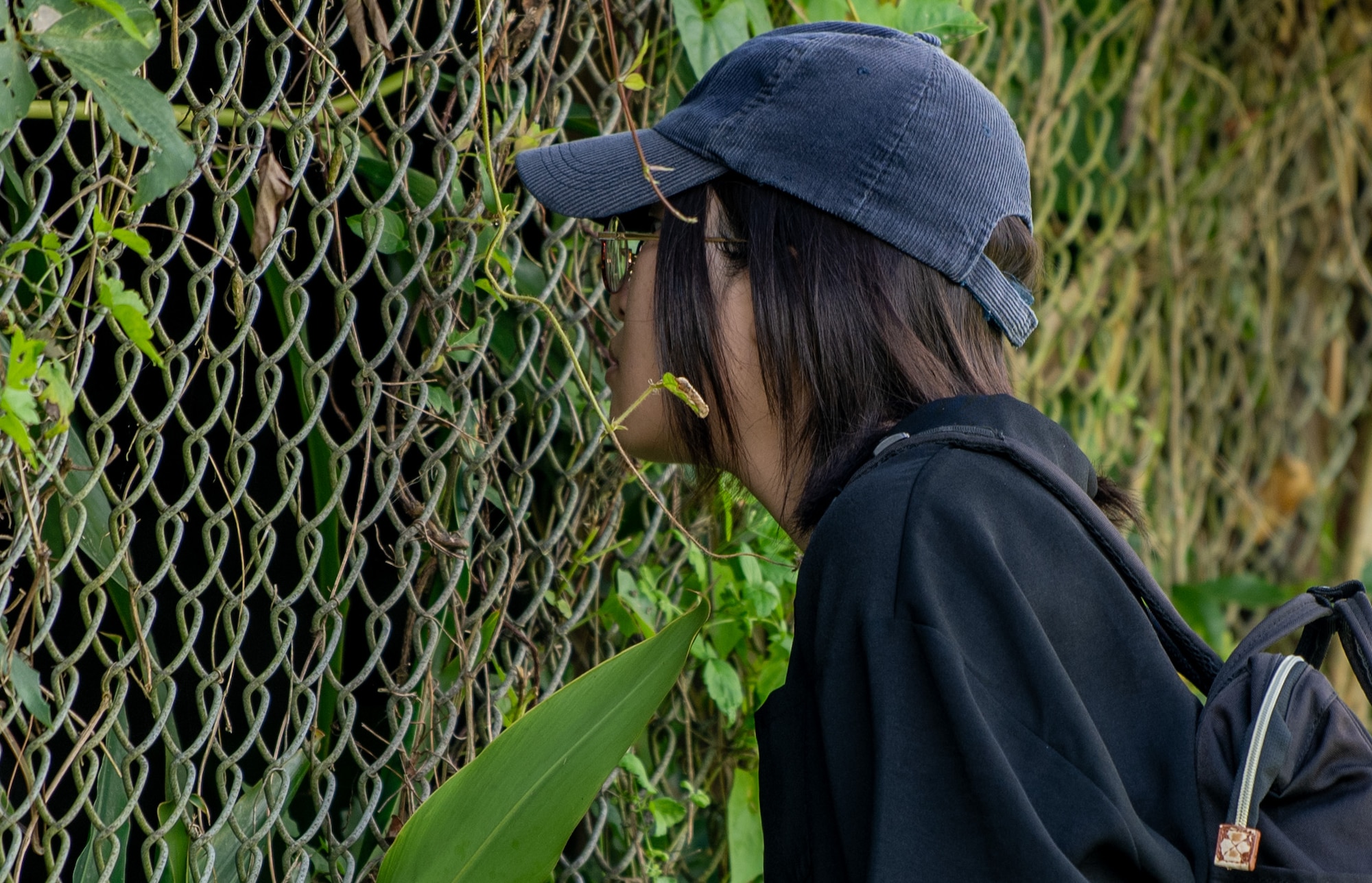 A local resident looks into a former hospital cave during a historical site tour of Kadena Air Base, Japan, Aug. 13, 2025.
