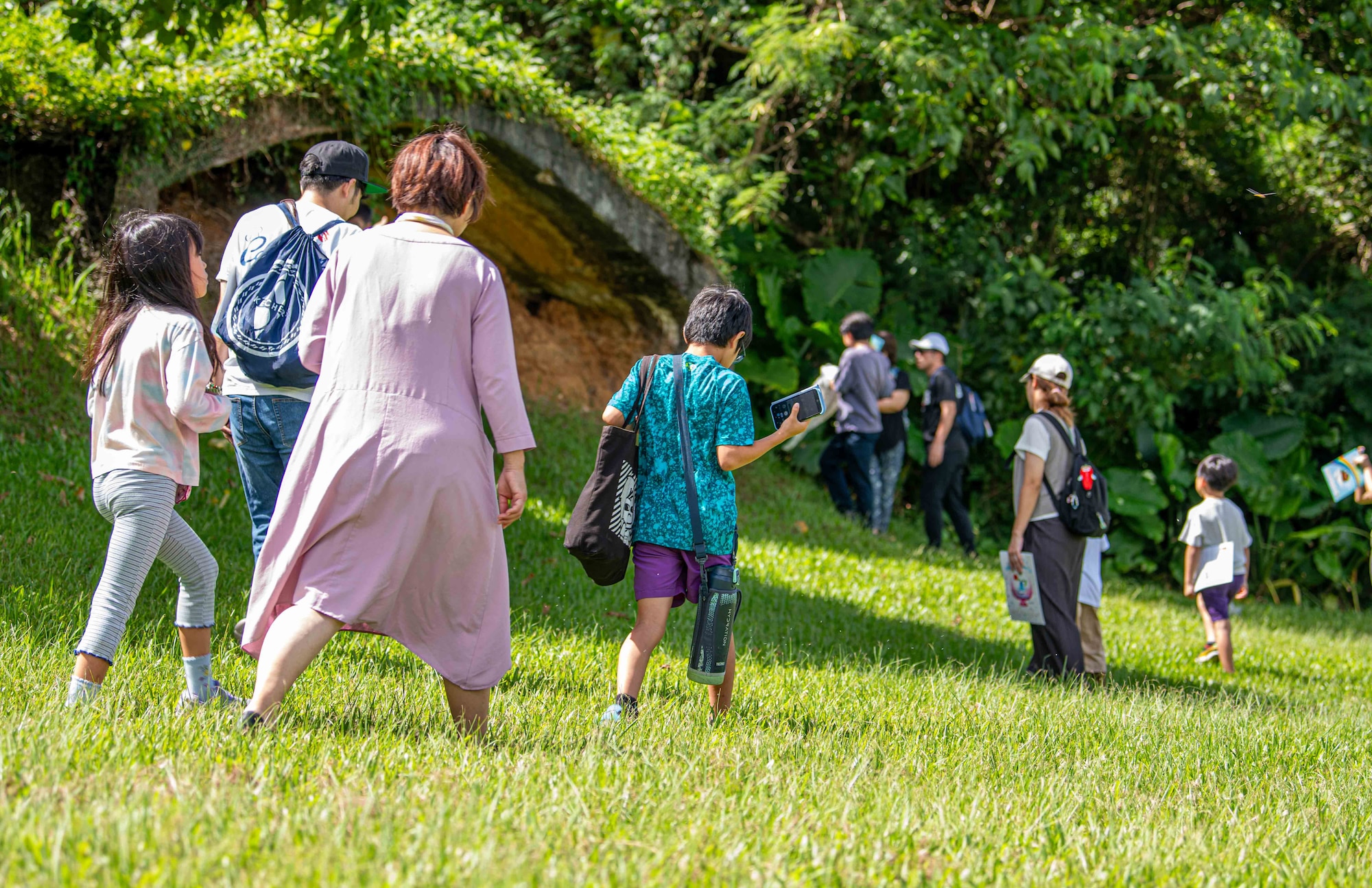 Local residents tour decommissioned Japanese WWII aircraft hangars during a historical site tour of Kadena Air Base, Japan, Aug. 13, 2025.