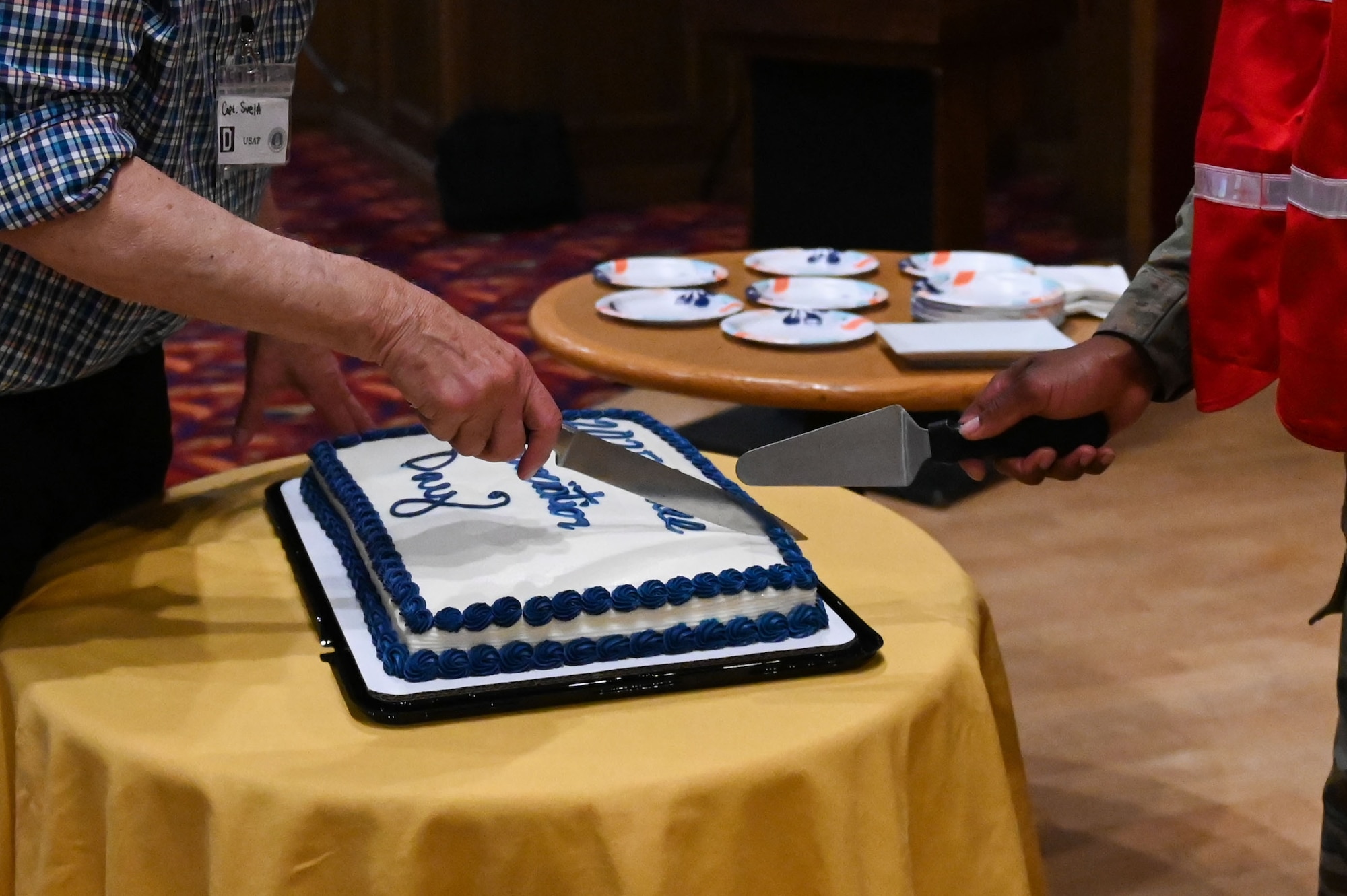 The 2025 Retiree Appreciation Day cake is cut at RAF Mildenhall, England, Aug. 15, 2025.
