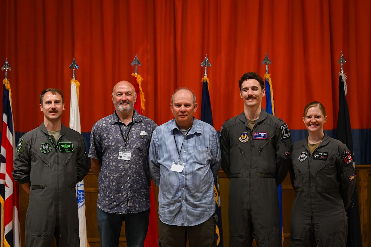 U.S. Air Force Airmen and retired servicemembers pose for a picture during the 2025 Retiree Appreciation Day at RAF Mildenhall, England, Aug. 15, 2025.