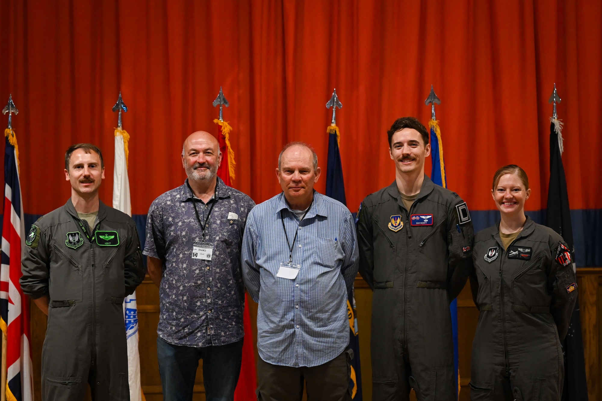 U.S. Air Force Airmen and retired servicemembers pose for a picture during the 2025 Retiree Appreciation Day at RAF Mildenhall, England, Aug. 15, 2025.