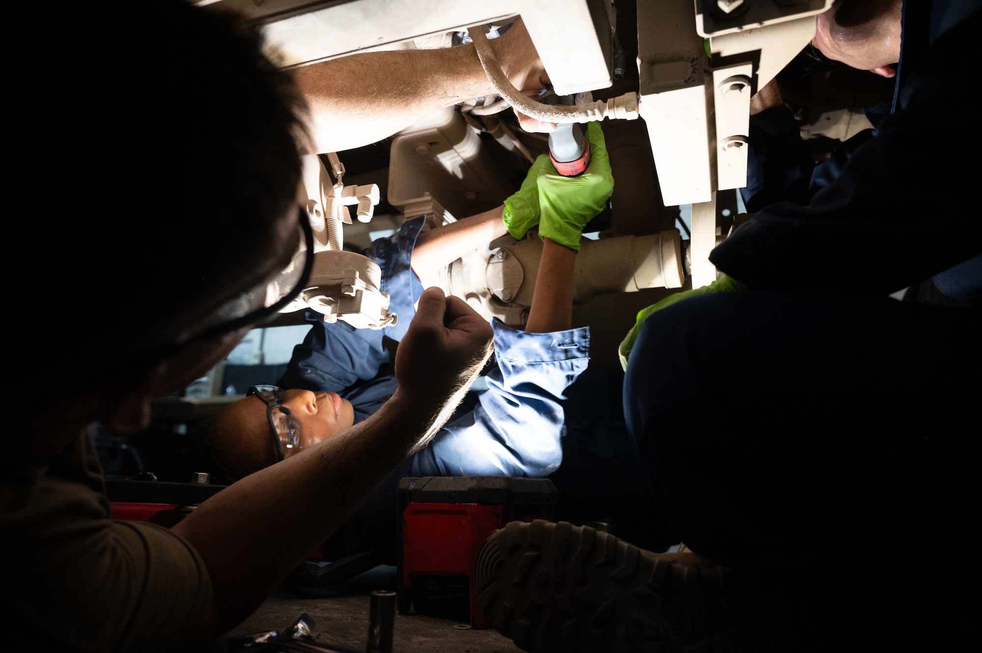 U.S. Air Force Chief Master Sgt. Carolyn A. Russell, 379th Air Expeditionary Wing command chief, uses an impact wrench during a “dirty jobs” unit immersion within the U.S. Central Command area of responsibility, Aug. 21, 2025. Responsible for everything from routine checks to major repairs, the 379th Expeditionary Logistics Readiness Squadron vehicle maintenance shop plays a vital role in sustaining base operations. (U.S. Air Force photo by Senior Airman Dieondiere Jefferies)