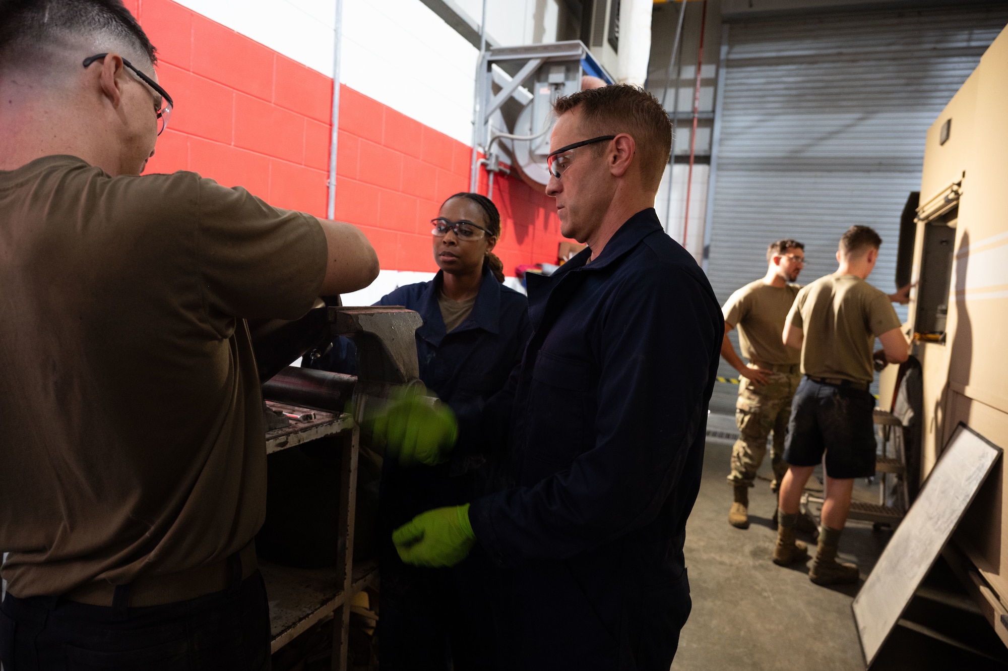 U.S. Air Force Chief Master Sgt. Carolyn A. Russell, 379th Air Expeditionary Wing command chief, uses an impact wrench during a “dirty jobs” unit immersion within the U.S. Central Command area of responsibility, Aug. 21, 2025. Responsible for everything from routine checks to major repairs, the 379th Expeditionary Logistics Readiness Squadron vehicle maintenance shop plays a vital role in sustaining base operations. (U.S. Air Force photo by Senior Airman Dieondiere Jefferies)
