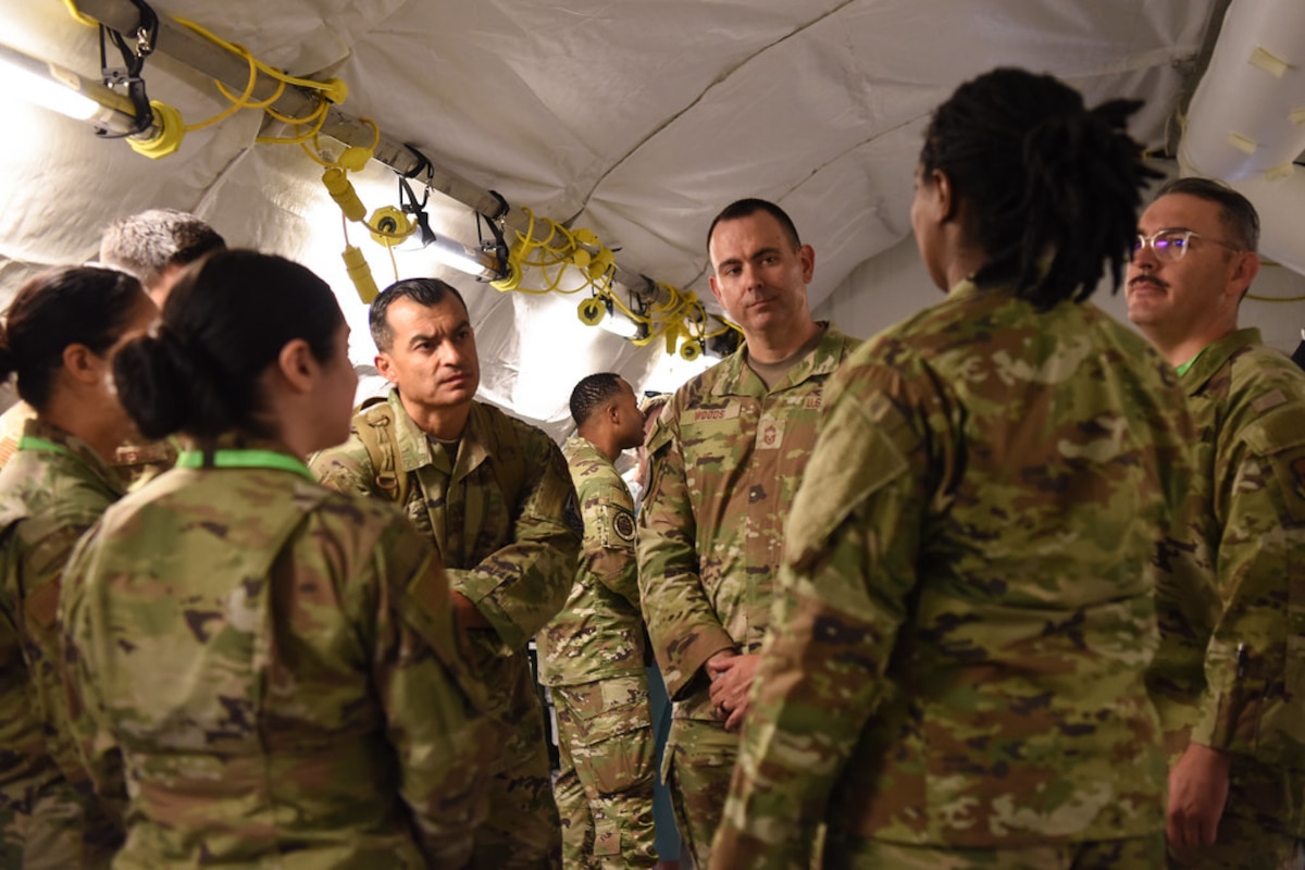 Image of Airmen observing and talking together.