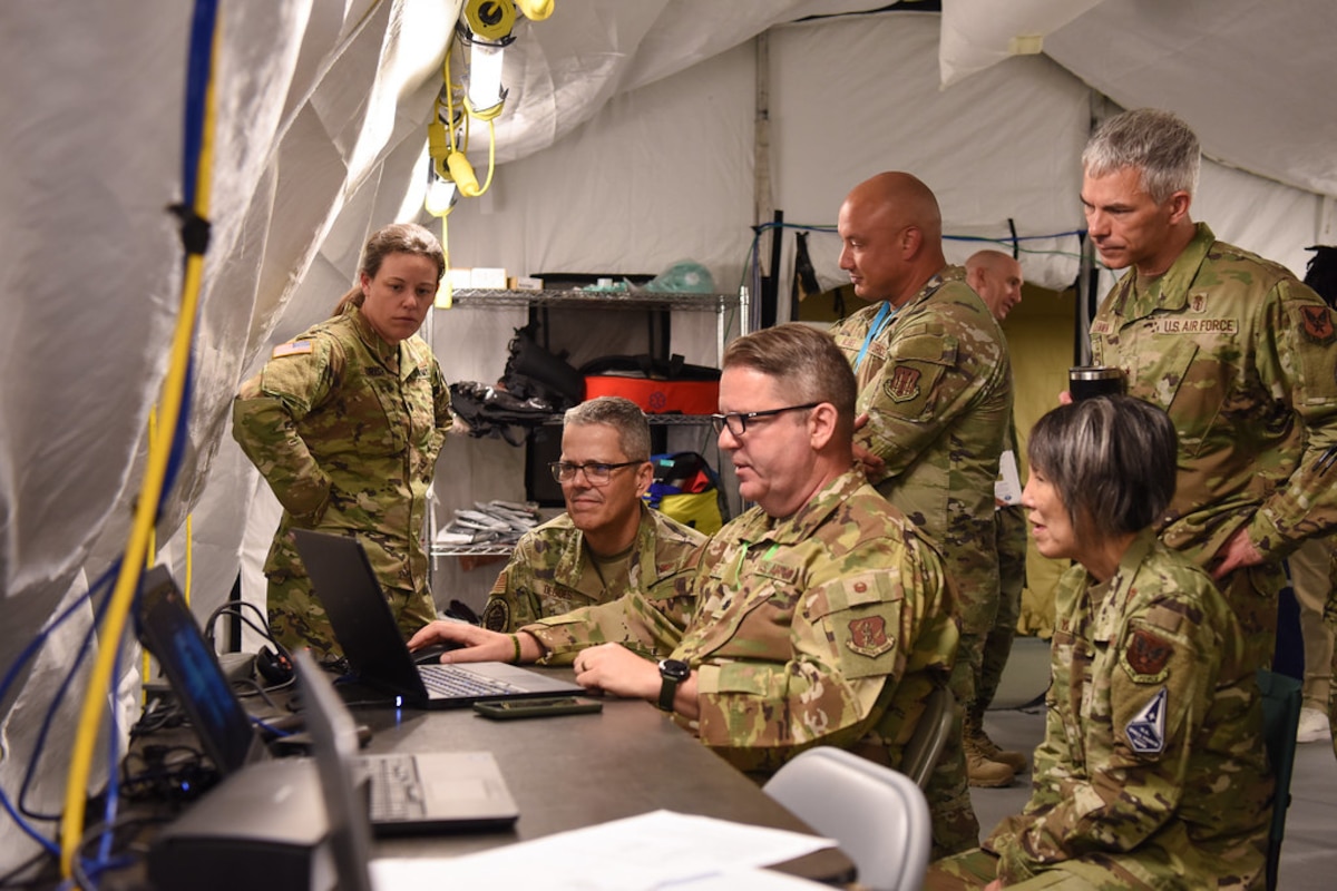 Image of Airmen observing and talking together.