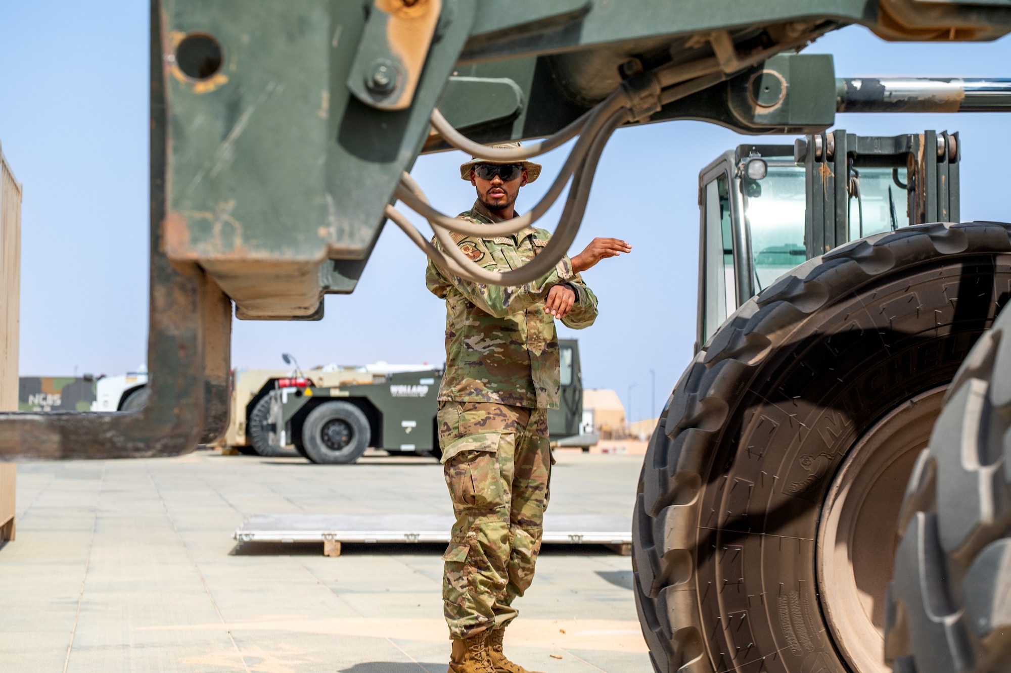 Airman directs a forklift