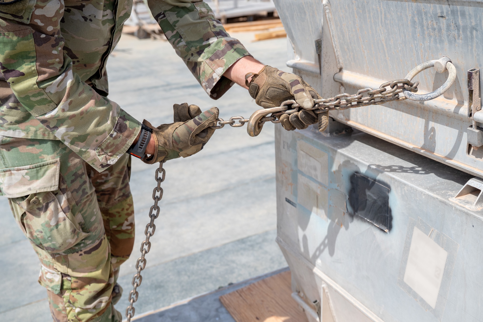 Airman pulls chain attached to cargo