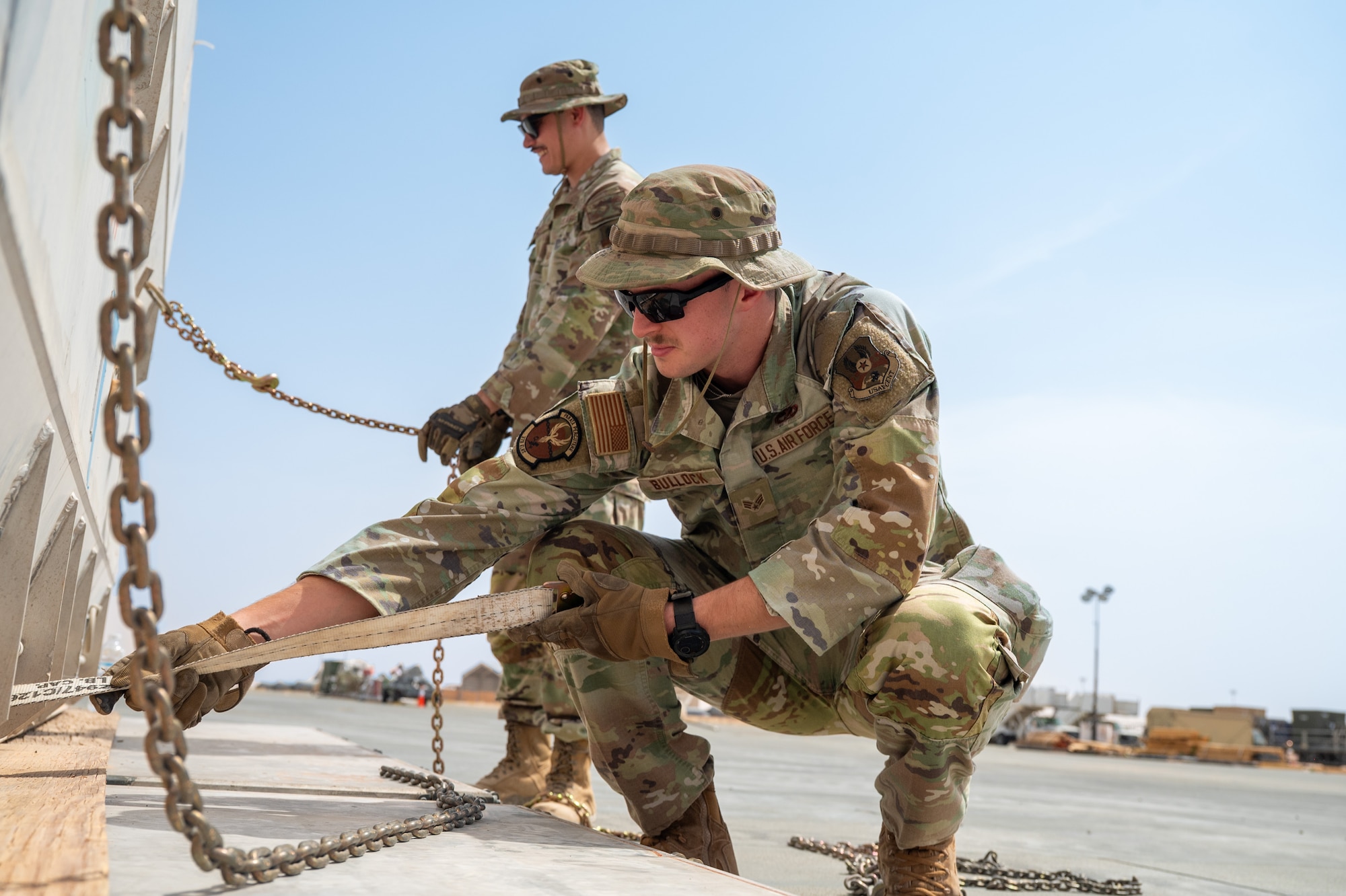 Airman pulls chain attached to cargo