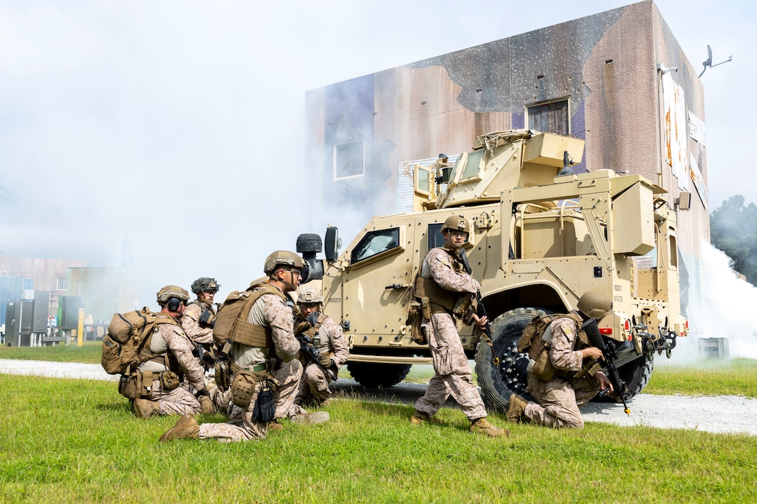 U.S. Marines with II Marine Expeditionary Force Support Battalion, participate in the Outdoor Infantry Immersion Trainer at Camp Lejeune, North Carolina, Aug. 19, 2025. The O-IIT provides a realistic training environment, allowing Marines to sharpen decision making, improve unit cohesion, and prepare for operational challenges in urban environments. (U.S. Marine Corps photo by Sgt. Jacquilyn Davis)