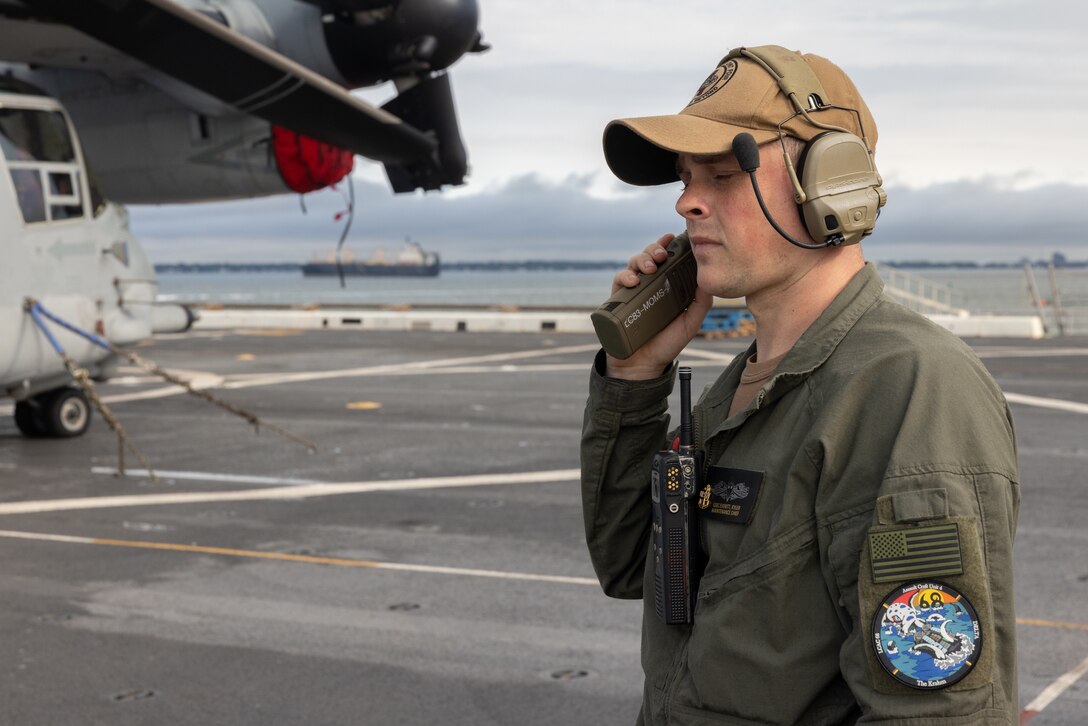 A U.S. Navy Chief Kyler Everitt with the San Antonio-class amphibious transport dock ship USS San Antonio (LPD 17), Iwo Jima Amphibious Ready Group, coordinates Landing Craft Air Cushion operations for the onloading of 22nd Marine Expeditionary Unit (Special Operations Capable) equipment and personnel to the San Antonio-class amphibious transport dock ship USS Fort Lauderdale (LPD 28), on Naval Base Norfolk, Virginia, August 19, 2025. Equipment and personnel were brought aboard the Fort Lauderdale, IWO ARG, in support of the 22nd MEU (SOC)’s regularly scheduled deployment. (U.S. Marine Corps photo by Lance Cpl. Kyle Baskin)