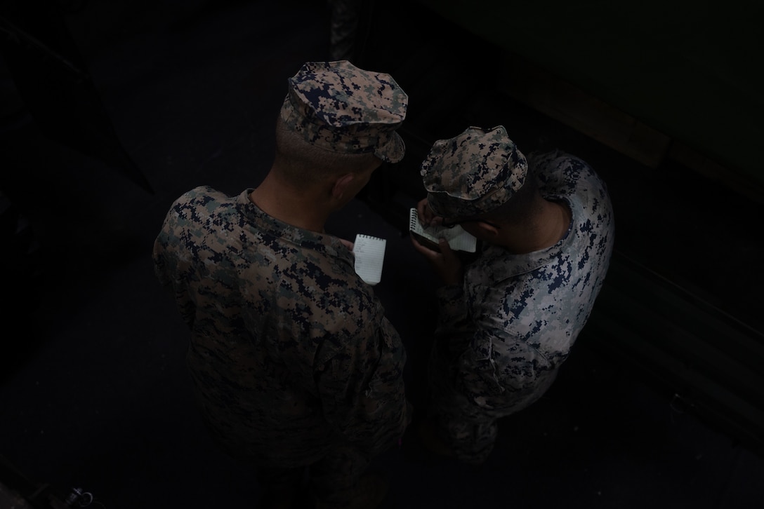 U.S. Marine Corps Lance Cpl. Edison Nevarez, left and Lance Cpl. David Maldonado, motor transport operators with Combat Logistics Battalion 26, 22nd Marine Expeditionary Unit (Special Operations Capable), exchange vehicle mileage and fuel data aboard the San Antonio-class amphibious transport dock ship USS San Antonio (LPD 17), while in port at Naval Station Norfolk, Virginia, August 21, 2025. U.S. Marines with the 22nd MEU (SOC) conducted preventative maintenance checks and services to ensure readiness of equipment and vehicles in support of the Iwo Jima Amphibious Readiness Group and 22nd MEU (SOC)’s regularly scheduled deployment. (U.S. Marine Corps photo by Sgt. Nathan Mitchell)