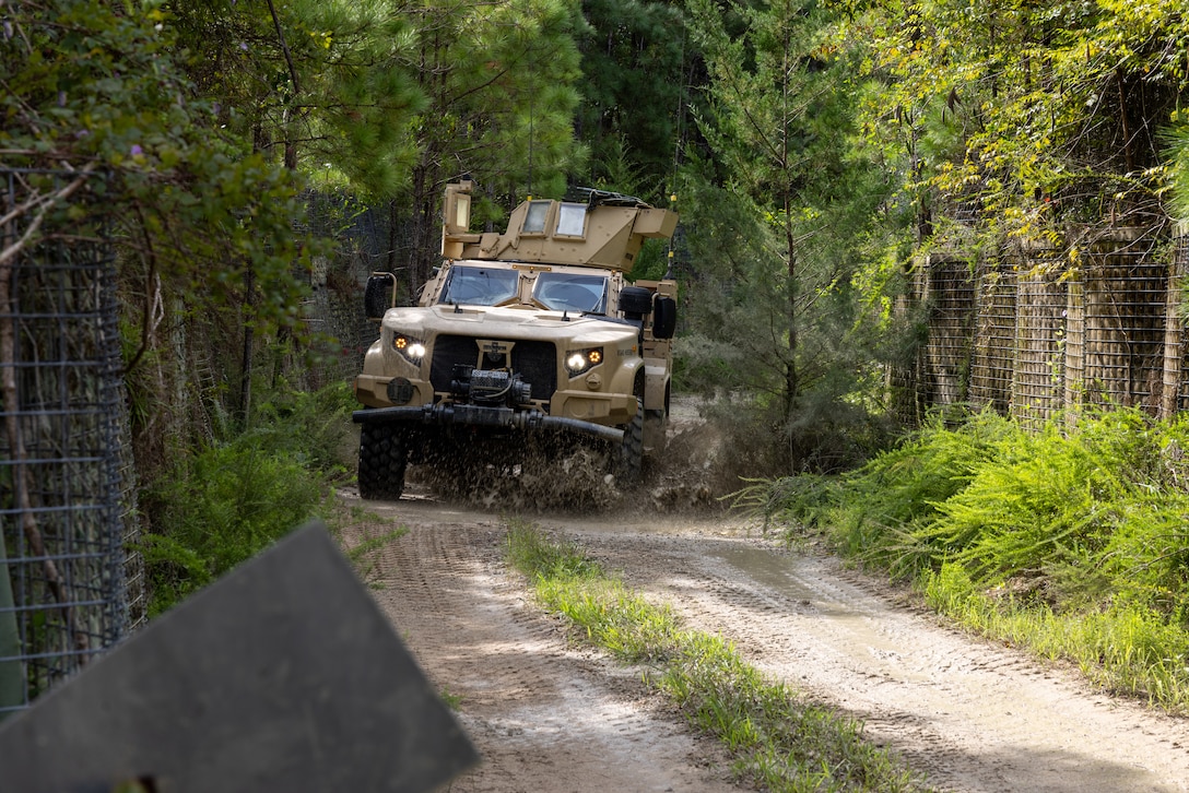 A joint light tactical vehicle from Combat Logistics Battalion 24, Combat Logistics Regiment 27, 2nd Marine Logistics Group, conduct combat vehicle operator training at Marine Corps Base Camp Lejeune, North Carolina, Aug. 21, 2025. The combat vehicle operator training was part of a Field Training Exercise to sustain training and readiness standards, increase Marines and Sailors’ technical proficiency in their military occupational specialties, and increase the battalions’ ability to complete core mission essential tasks. (U.S. Marine Corps photo by Cpl. Apollo Wilson)