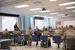 A mobile training team instructor from North American Aerospace Defense Command (NORAD) and U.S. Northern Command (USNORTHCOM) prepares joint staff planners from the Georgia National Guard for a classroom exercise during a Joint Forces Headquarters/Joint Task Force Staff Training Course (JSTC) at the Clay National Guard Center in Marietta, Ga., August 19, 2025.