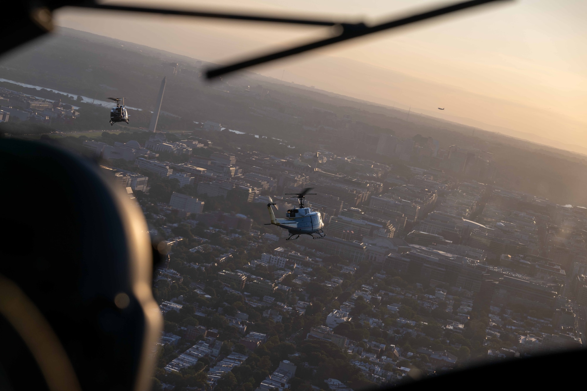 Two U.S. Air Force UH-1N helicopters assigned to the 1st Helicopter Squadron fly over Washington, D.C., Aug. 23, 2025. Upon completion of a flyover for the D.C. United vs. Inter Miami soccer game, the 1st Helicopter Squadron conducted training to practice formation landing and takeoff safety procedures.