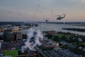 Two U.S. Air Force UH-1N helicopters assigned to the 1st Helicopter Squadron fly over Audi Field in Washington, D.C., Aug. 23, 2025. The event showcased the planning and teamwork between the 1st Helicopter Squadron and game officials to synchronize the flyover with the pregame ceremony.
