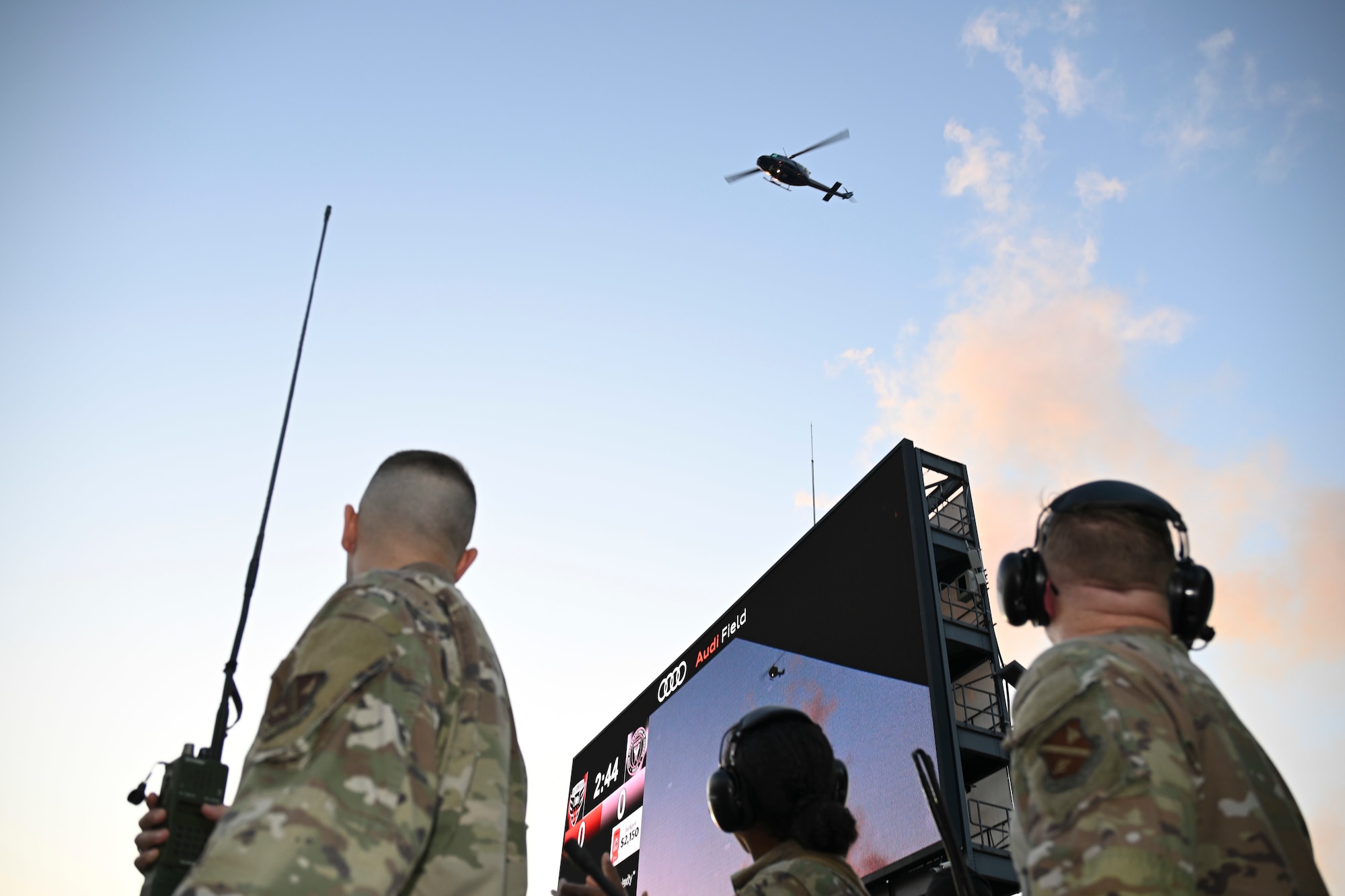 U.S. Air Force Airmen assigned to the 1st Helicopter Squadron observe a UH-1N helicopter passing over Audi Field during a flyover in Washington, D.C., Aug. 23, 2025. The flyover occurred at the conclusion of the national anthem before the D.C. United vs. Inter Miami soccer game.