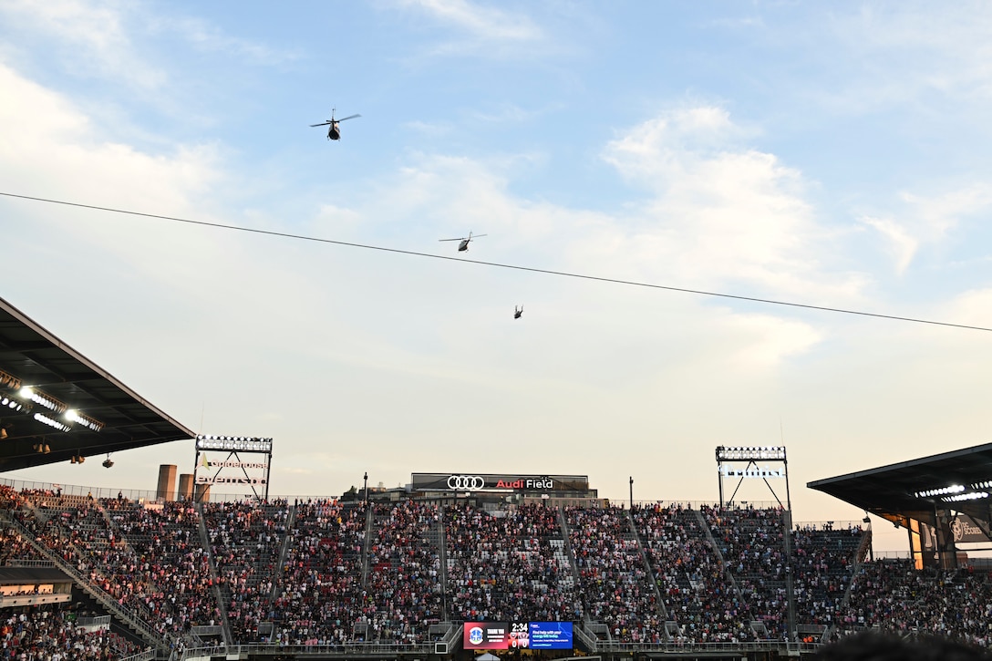 Three U.S. Air Force UH-1N helicopters assigned to the 1st Helicopter Squadron fly over Audi Field in Washington, D.C., Aug. 23, 2025. The event showcased the planning and teamwork between the 1st Helicopter Squadron and game officials to synchronize the flyover with the pregame ceremony.