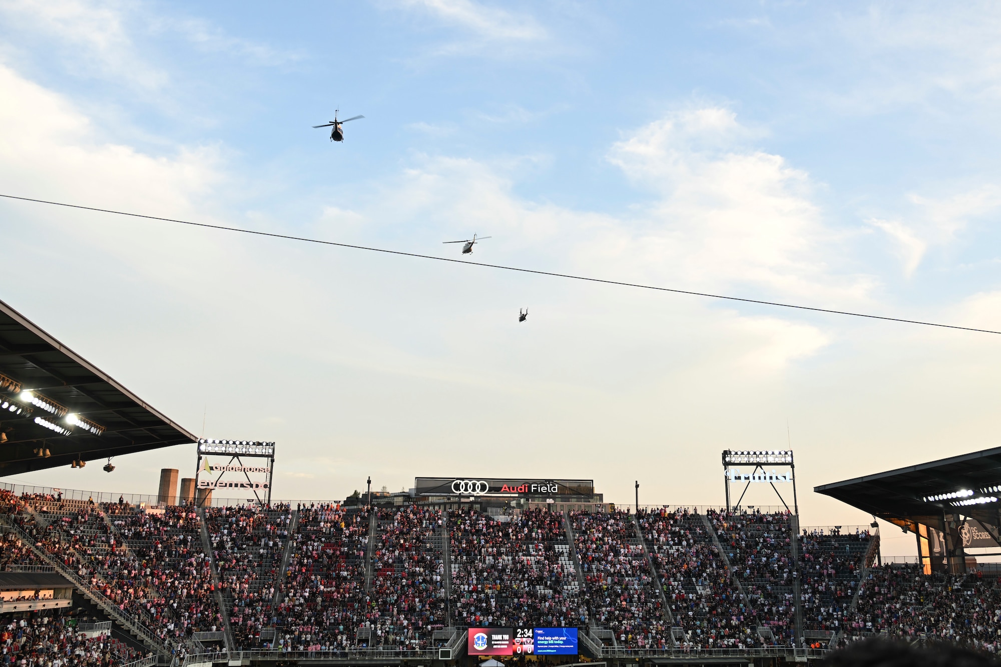 Three U.S. Air Force UH-1N helicopters assigned to the 1st Helicopter Squadron fly over Audi Field in Washington, D.C., Aug. 23, 2025. The event showcased the planning and teamwork between the 1st Helicopter Squadron and game officials to synchronize the flyover with the pregame ceremony.