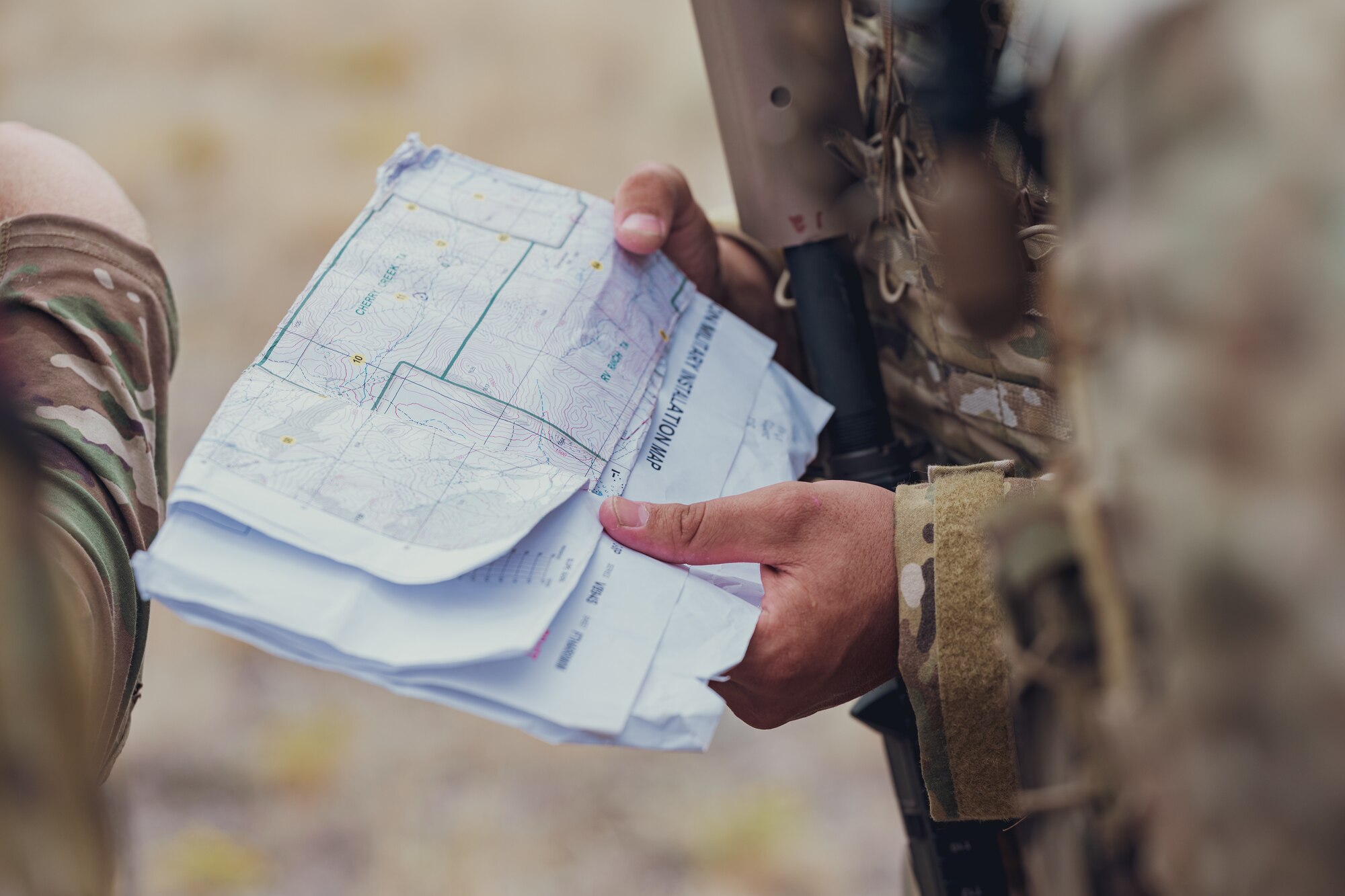 A close shot of an Airman holding a map.