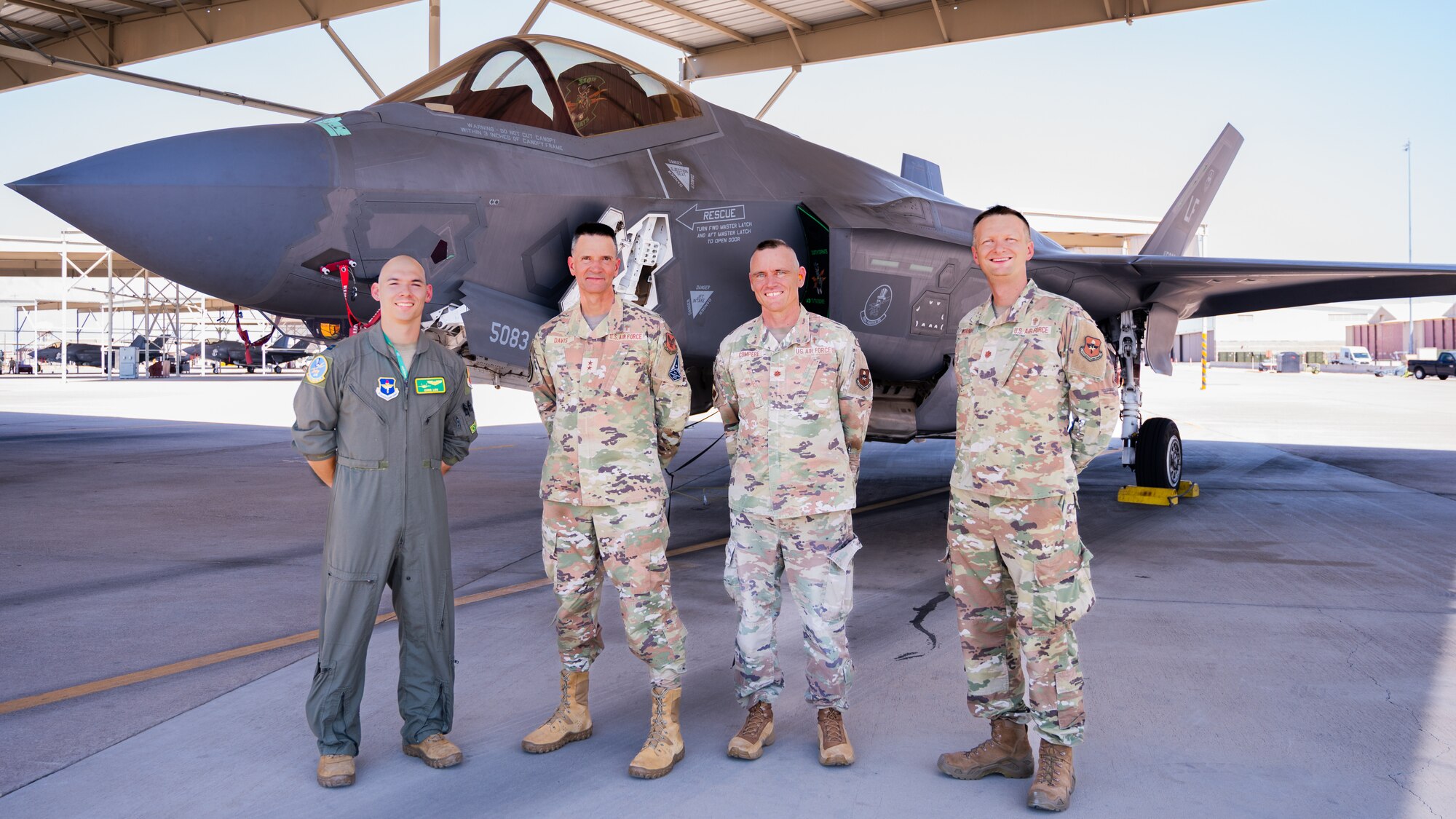 U.S. Air Force Maj. Gen. Trent Davis (center left), Department of the Air Force chief of chaplains, stands in front of an F-35A Lighting II with Capt. Christopher Loo (left), 310th Fighter Squadron instructor pilot, Lt. Col. Robert Compere (center right), 56th Fighter Wing chaplain, and Lt. Col. Portmann Werner (right), 56th FW chaplain, during a squadron visit, Aug. 22, 2025, at Luke Air Force Base, Arizona.