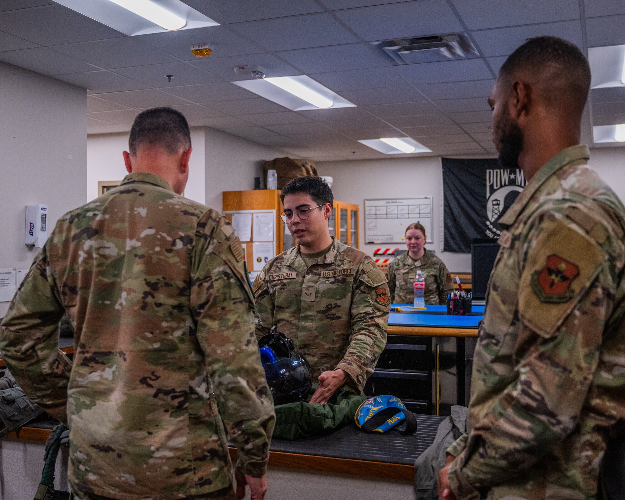 U.S. Air Force Airman 1st Class Ethan Christobal, 56th Operational Support Squadron aircrew flight equipment specialist, teaches Maj. Gen. Trent Davis, Department of the Air Force chief of chaplains, about F-35A Lighting II equipment during a squadron visit, Aug. 22, 2025, at Luke Air Force Base, Arizona.