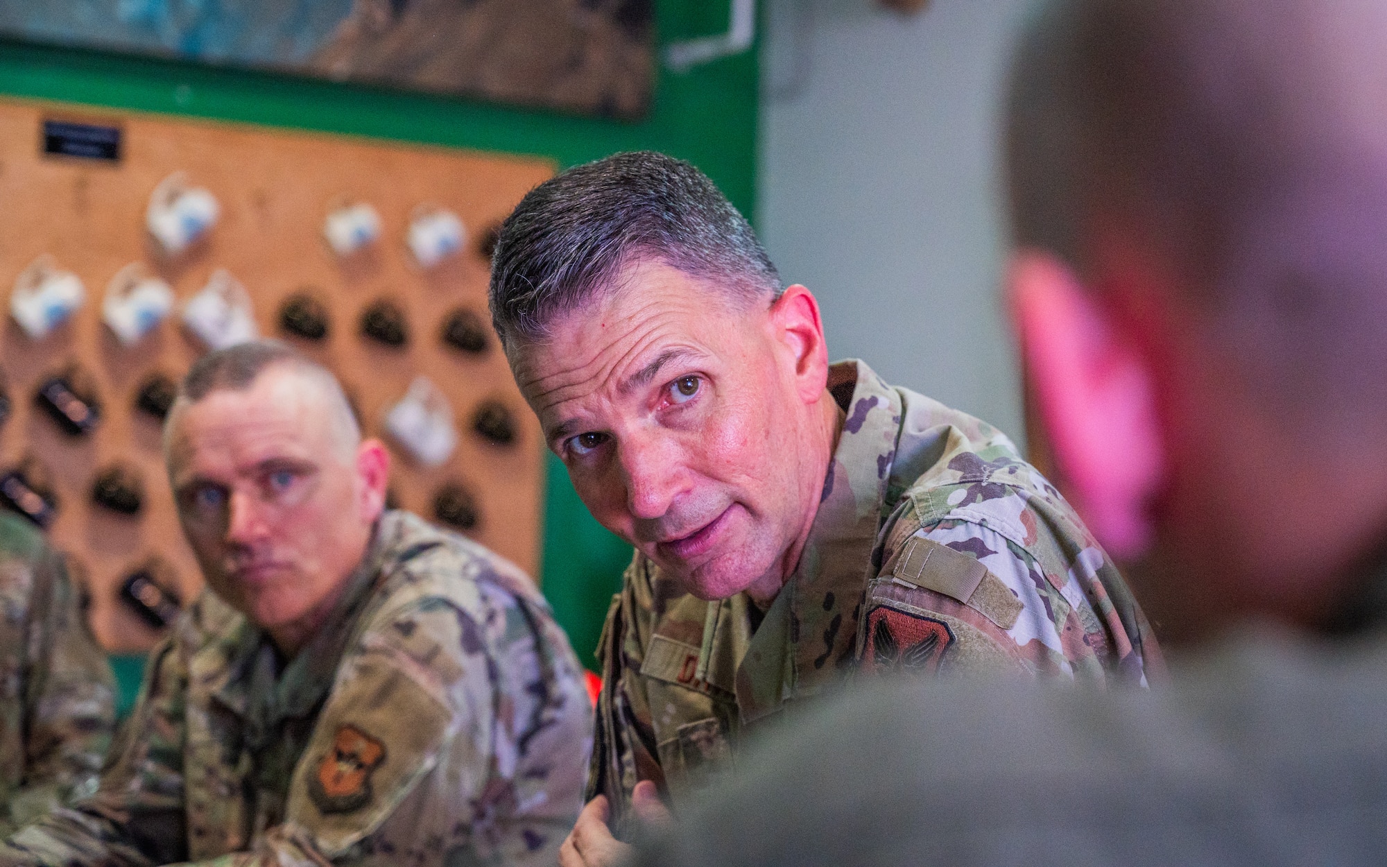 U.S. Air Force Maj. Gen. Trent Davis (right), Department of the Air Force chief of chaplains, speaks with Airmen during a squadron visit, Aug. 22, 2025, at Luke Air Force Base, Arizona.