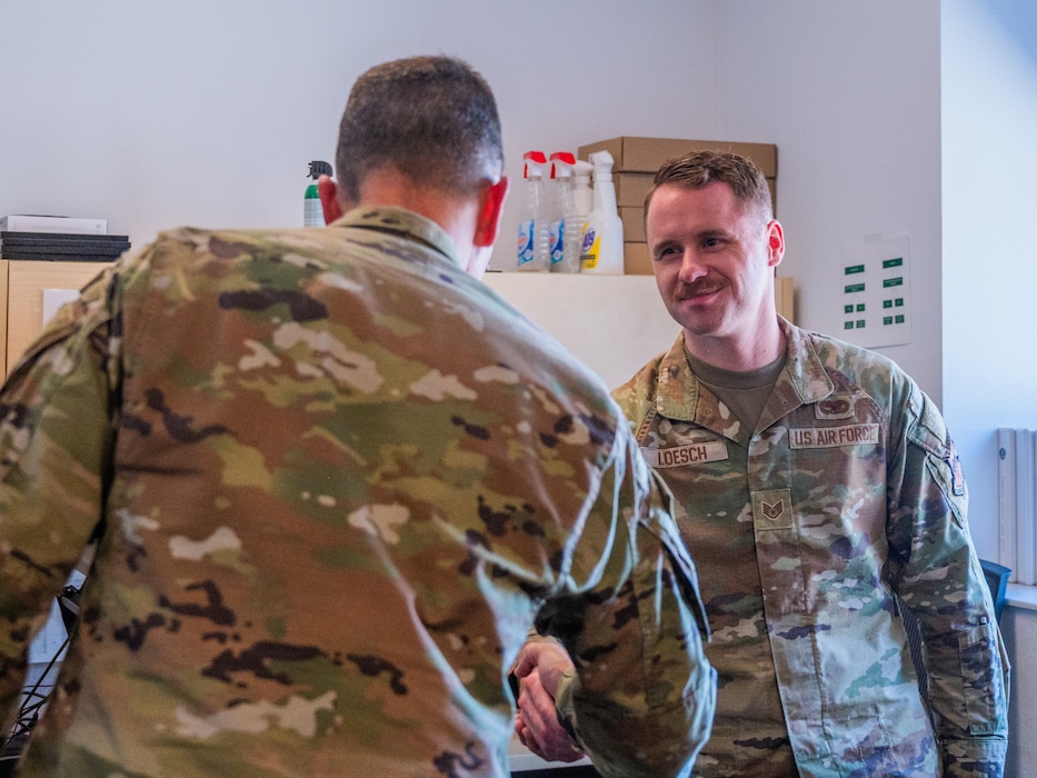 U.S. Air Force Maj. Gen. Trent Davis (left), Department of the Air Force chief of chaplains, speaks with Staff Sgt. Nathan Loesch, 310th Aircraft Maintenance Unit crew chief, during a squadron visit, Aug. 22, 2025, at Luke Air Force Base, Arizona.
