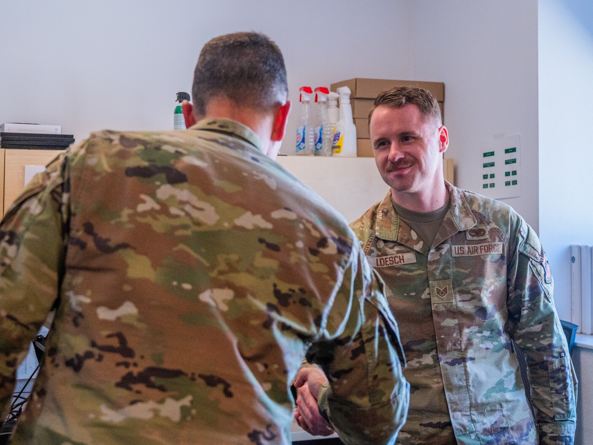 U.S. Air Force Maj. Gen. Trent Davis (left), Department of the Air Force chief of chaplains, speaks with Staff Sgt. Nathan Loesch, 310th Aircraft Maintenance Unit crew chief, during a squadron visit, Aug. 22, 2025, at Luke Air Force Base, Arizona.