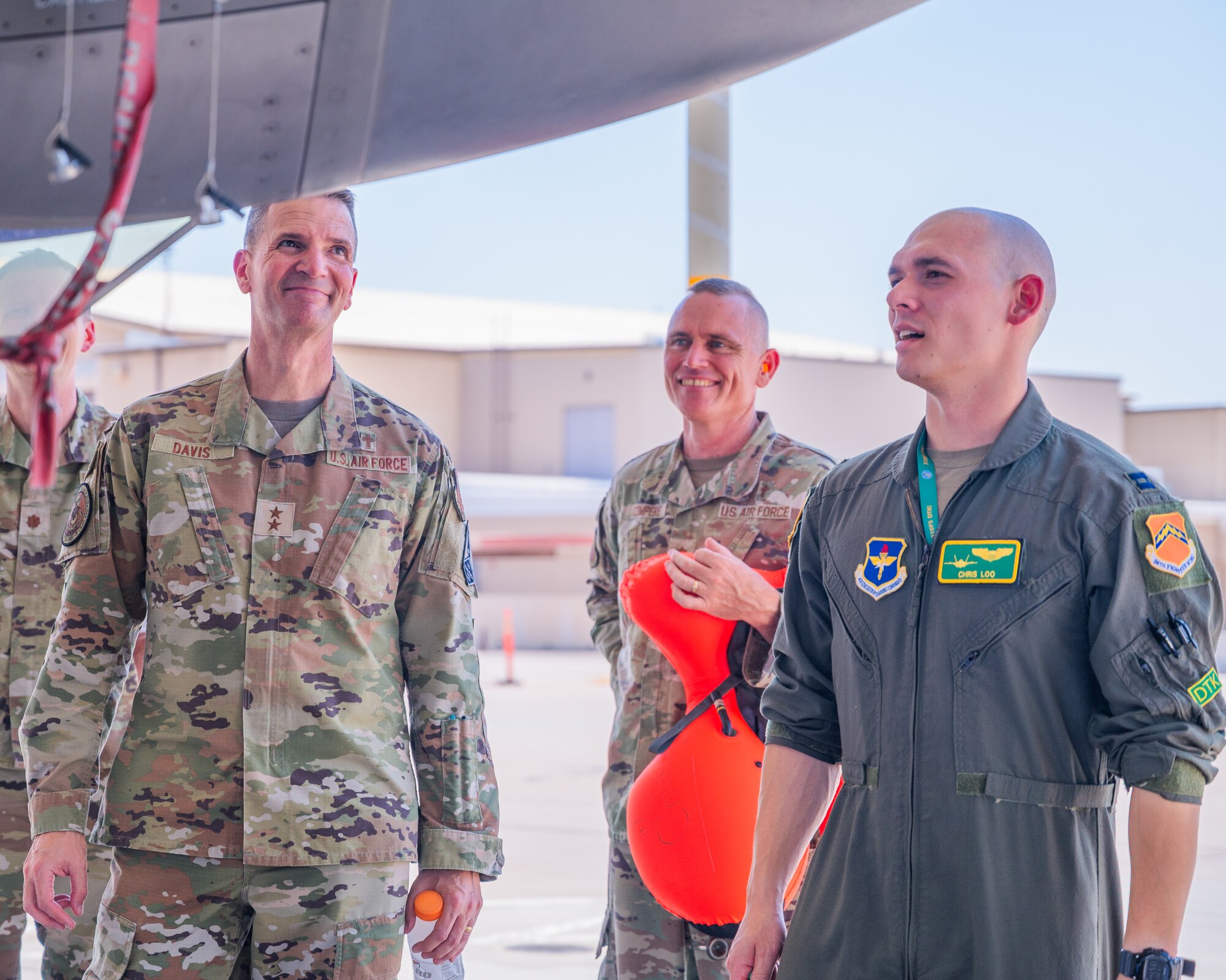 U.S. Air Force Capt. Christopher Loo (Right), 310th Fighter Squadron instructor pilot, gives Maj. Gen. Trent Davis (left), Department of the Air Force chief of chaplains, and Lt. Col. Robert Compere (center), 56th Fighter Wing chaplain, a tour of an F-35A Lighting II during a squadron visit, Aug. 22, 2025, at Luke Air Force Base, Arizona.