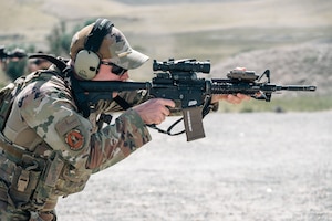 An Airman shoots at a target.