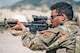 An Airman shoots at a target.