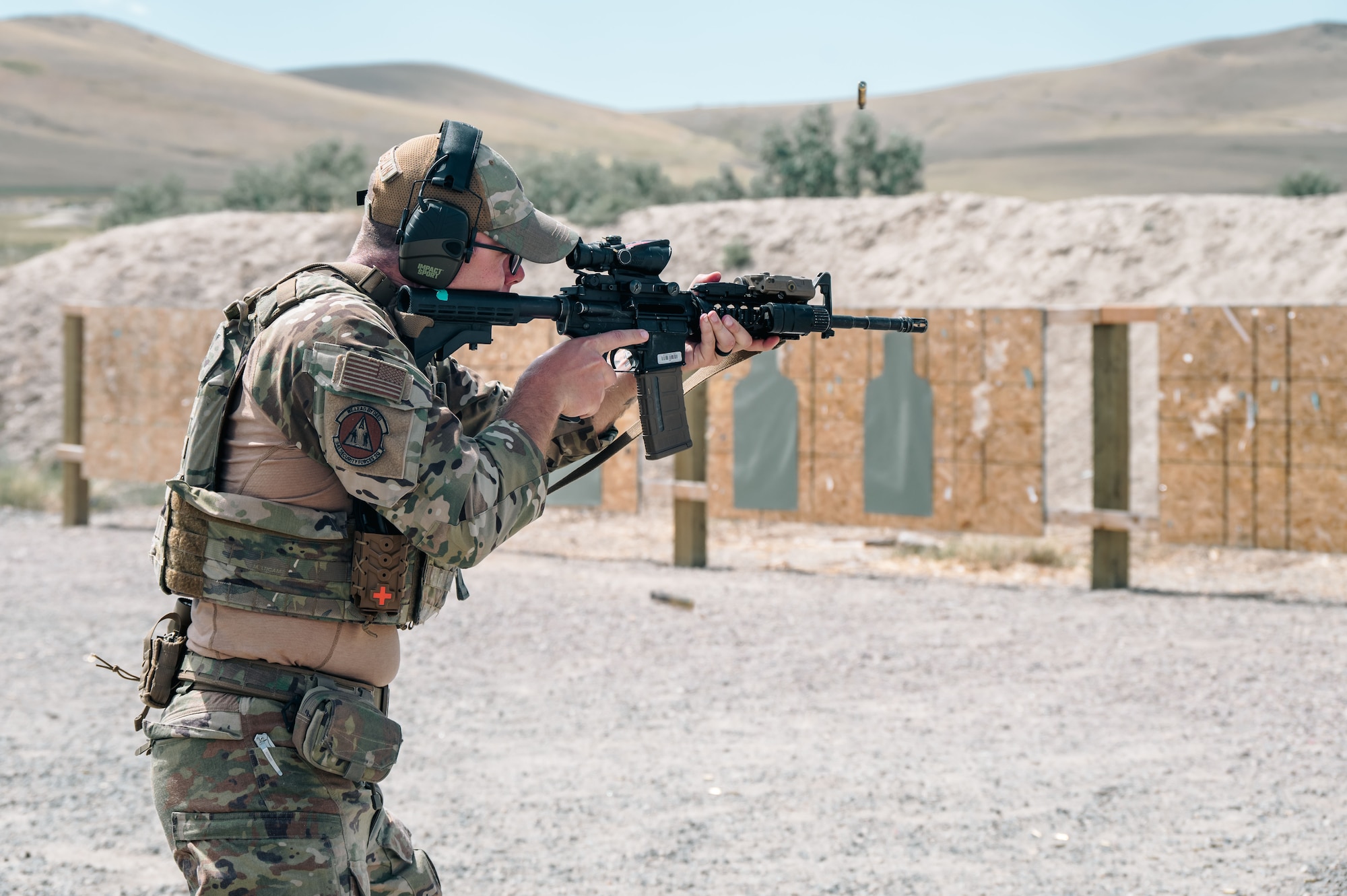An Airman shoots at a target.
