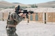 An Airman shoots at a target.