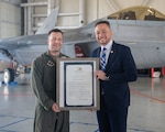 Del. Michael Feggans presents Virginia General Assembly House Joint Resolution No. 189 to Master Sgt. Stephen Drakes Aug. 10, 2025, during a visit to the 192nd Wing at Joint Base Langley-Eustis in Hampton, Virginia. Drakes is assigned to the 192nd Operations Support Squadron, 192nd Wing and serves as the flight chief, wing weapons and tactics, and survival evasion resistance and escape specialist noncommissioned officer in charge. Read the full resolution at https://vngpao.info/2d48s4rk.