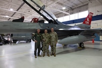 From left, U.S. Air Force Maj. Gen. Gregory Kreuder, commander, 19th Air Force, Tech. Sgt. Andrew Quiroz, 162nd Aircraft Maintenance Squadron avionics technician, and Chief Master Sgt. Keith Scott, command chief 19th Air Force, gather for a photo  at Morris Air National Guard Base, Ariz., Aug. 19, 2025. Quiroz was recognized for his contributions to the maintenance of Aircraft 379. Aircraft 379, critical for student pilot training, underwent depot-level maintenance, averting a year long wait and saving millions of dollars. This initiative exemplifies the 162nd Wing’s commitment to efficient resource management in support of the 19th Air Force mission to produce the next generation of aviators. (U.S. Air National Guard photo by Staff Sgt. Guadalupe Beltran)