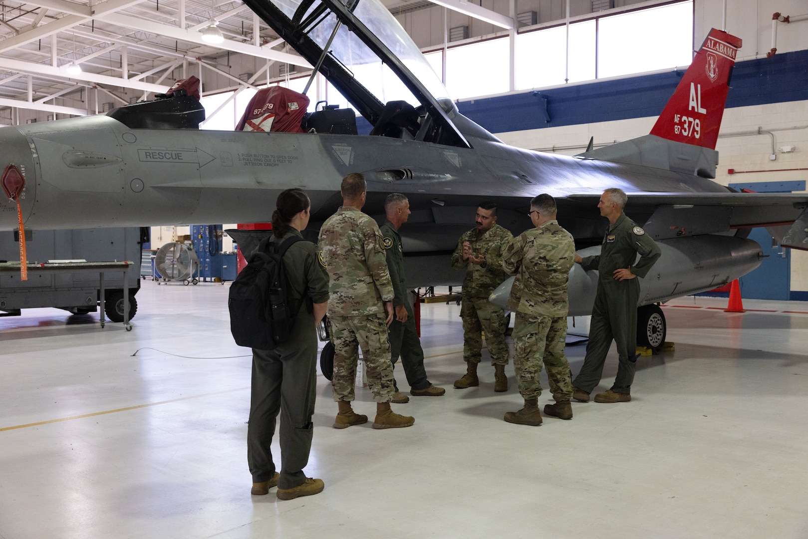 The 19th Air Force and 162nd Wing leadership team gather to receive an update on F-16D aircraft 379 at Morris Air National Guard Base, Ariz., Aug. 19, 2025. Aircraft 379, critical for student pilot training, underwent depot-level maintenance, averting a year long delay and saved millions of dollars. This initiative exemplifies the 162nd Wing’s commitment to efficient resource management in support of the 19th Air Force mission to produce the next generation of aviators. (U.S. Air National Guard photo by Staff Sgt. Guadalupe Beltran)