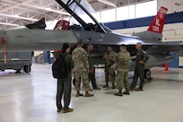 The 19th Air Force and 162nd Wing leadership team gather to receive an update on F-16D aircraft 379 at Morris Air National Guard Base, Ariz., Aug. 19, 2025. Aircraft 379, critical for student pilot training, underwent depot-level maintenance, averting a year long delay and saved millions of dollars. This initiative exemplifies the 162nd Wing’s commitment to efficient resource management in support of the 19th Air Force mission to produce the next generation of aviators. (U.S. Air National Guard photo by Staff Sgt. Guadalupe Beltran)