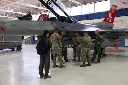 The 19th Air Force and 162nd Wing leadership team gather to receive an update on F-16D aircraft 379 at Morris Air National Guard Base, Ariz., Aug. 19, 2025. Aircraft 379, critical for student pilot training, underwent depot-level maintenance, averting a year long delay and saved millions of dollars. This initiative exemplifies the 162nd Wing’s commitment to efficient resource management in support of the 19th Air Force mission to produce the next generation of aviators. (U.S. Air National Guard photo by Staff Sgt. Guadalupe Beltran)