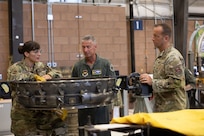 From left, U.S. Air National Guard Master Sgt. Stacey Rodriguez, 162nd Jet Engine Intermediate Maintenance supervisor, U.S. Air Force Maj. Gen. Gregory Kreuder, commander 19th Air Force, and Chief Master Sgt. Keith Scott, command chief 19th Air Force, discuss aircraft engine maintenance at the Jet Engine Intermediate Maintenance section at Morris Air National Guard Base, Ariz., Aug. 19, 2025. While most units only have one engine type, the 162nd JEIM has a dual configuration that supports simultaneous maintenance on both General Electric and Pratt & Whitney engines. By sustaining two fully equipped support sections, the wing maintains unmatched flexibility to support multiple F-16 blocks and diverse mission requirements. (U.S. Air National Guard photo by Staff Sgt. Guadalupe Beltran)
