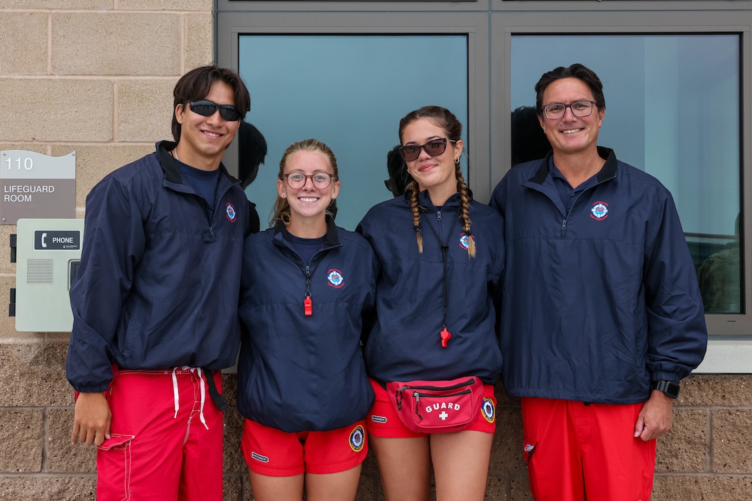 Lifeguards at the 21 Area Combat Water Survival Training Facility stand for a group photo during the ribbon-cutting ceremony for the 21 Area Combat Water Survival Training Facility at Marine Corps Base Camp Pendleton, California, Aug. 13, 2025. The newly constructed facility will be capable of hosting training events such as Marine Corps swim qualification, Underwater Egress Training, and Submerged Vehicle Egress Training to ensure readiness and maintain amphibious capabilities. (U.S. Marine Corps photo by Cpl. Jacqueline Akamelu)