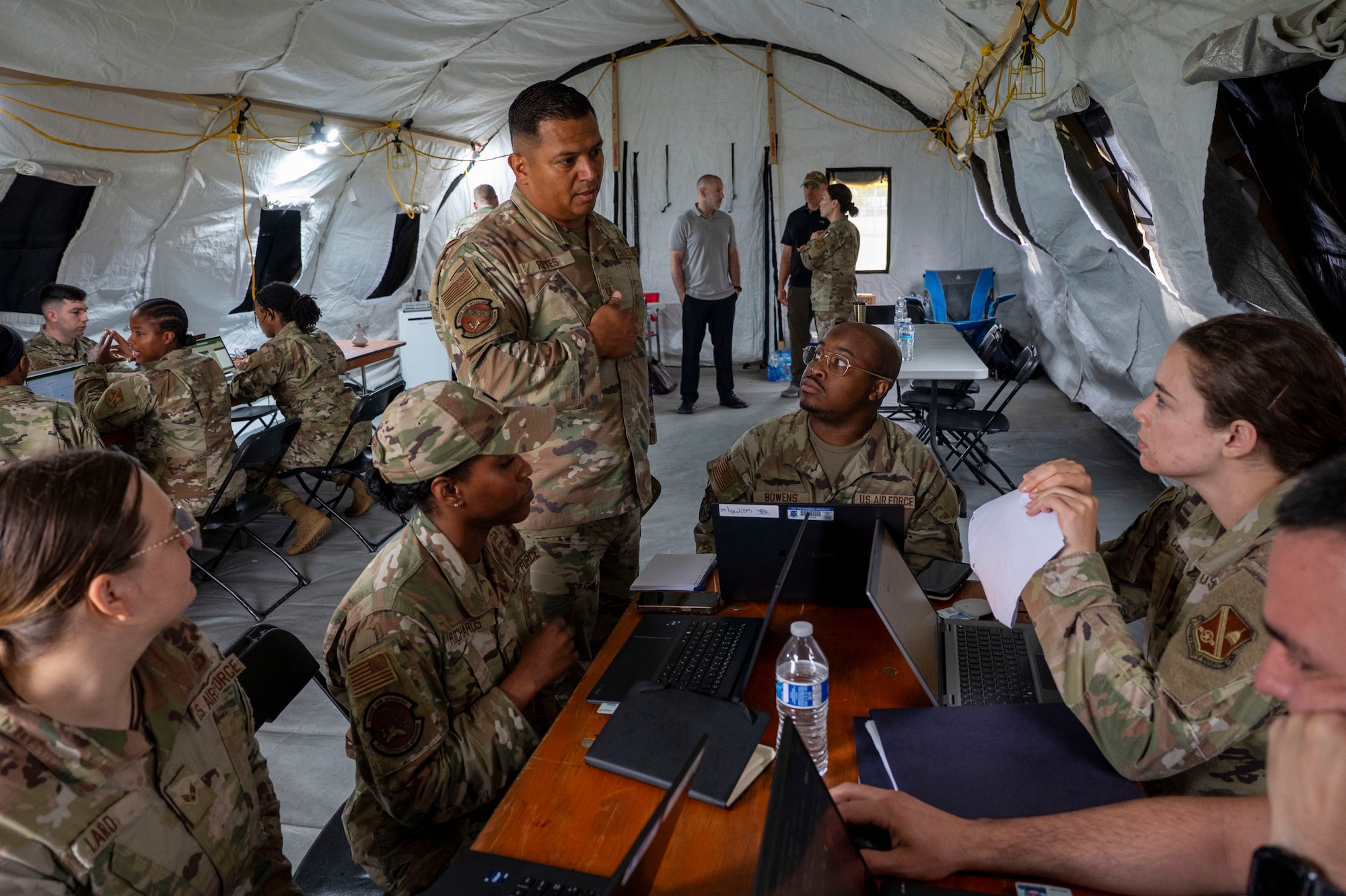 U.S. Air Force Master Sgt. Michael H. Reyes, 11th Contracting Squadron senior enlisted leader, instructs a group of Airmen during a field training exercise at Joint Base Anacostia-Bolling, Washington, D.C., Aug. 19, 2025. The 11th CONS executed annual requirements during a three-day exercise that included briefing the wing commander. (U.S. Air Force photo by Staff Sgt. Jordan Powell)